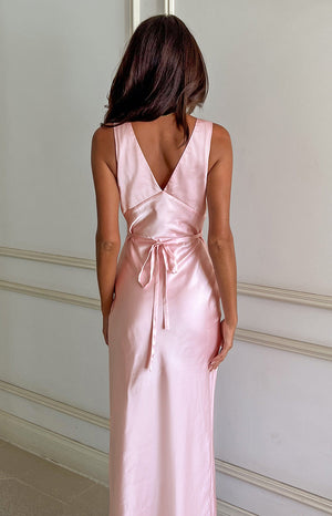 Rear view of a pink satin maxi dress with a deep V-back and a self-tie waist
