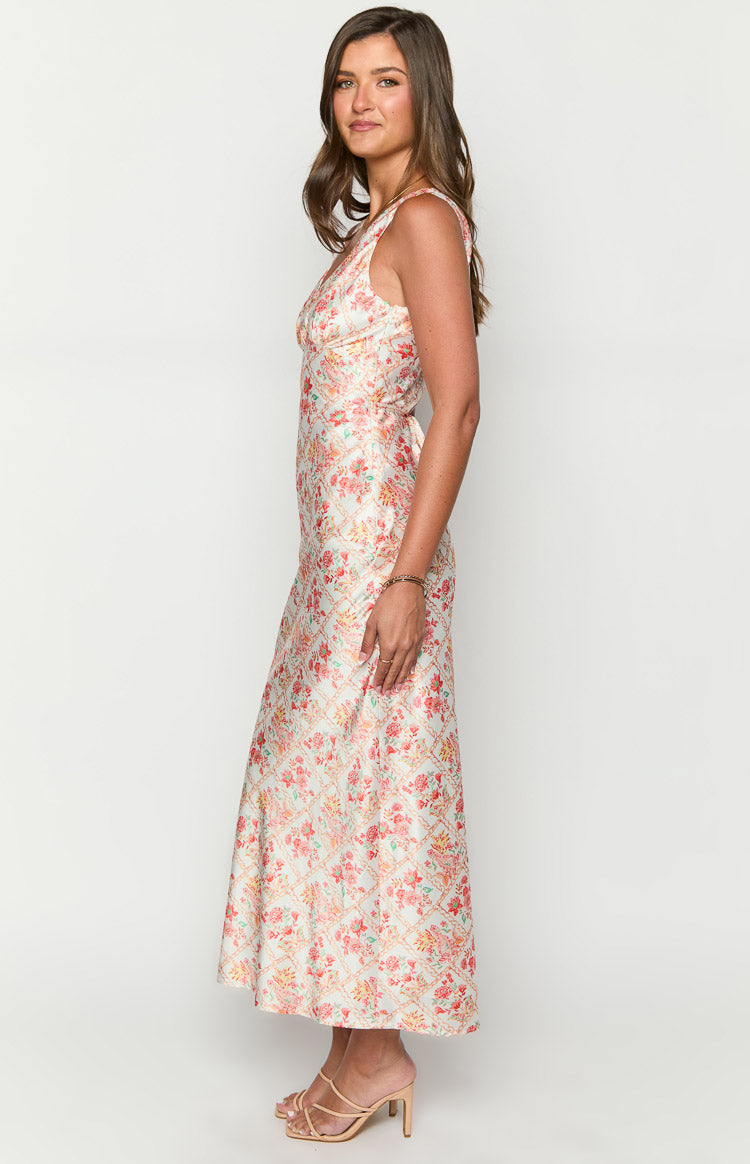 Side view of a white floral paisley maxi dress with a V-neckline and tie-back detail