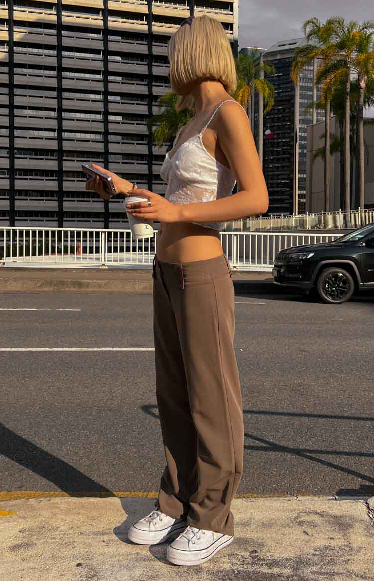 Side view of taupe low waist straight leg pants showing the relaxed fit and full length