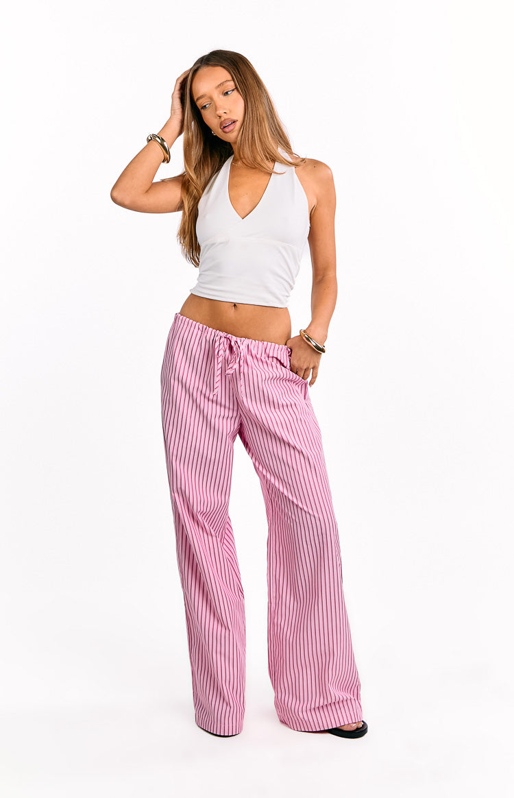 Pink wide-leg pants with thin black vertical stripes and a drawstring elasticated waist