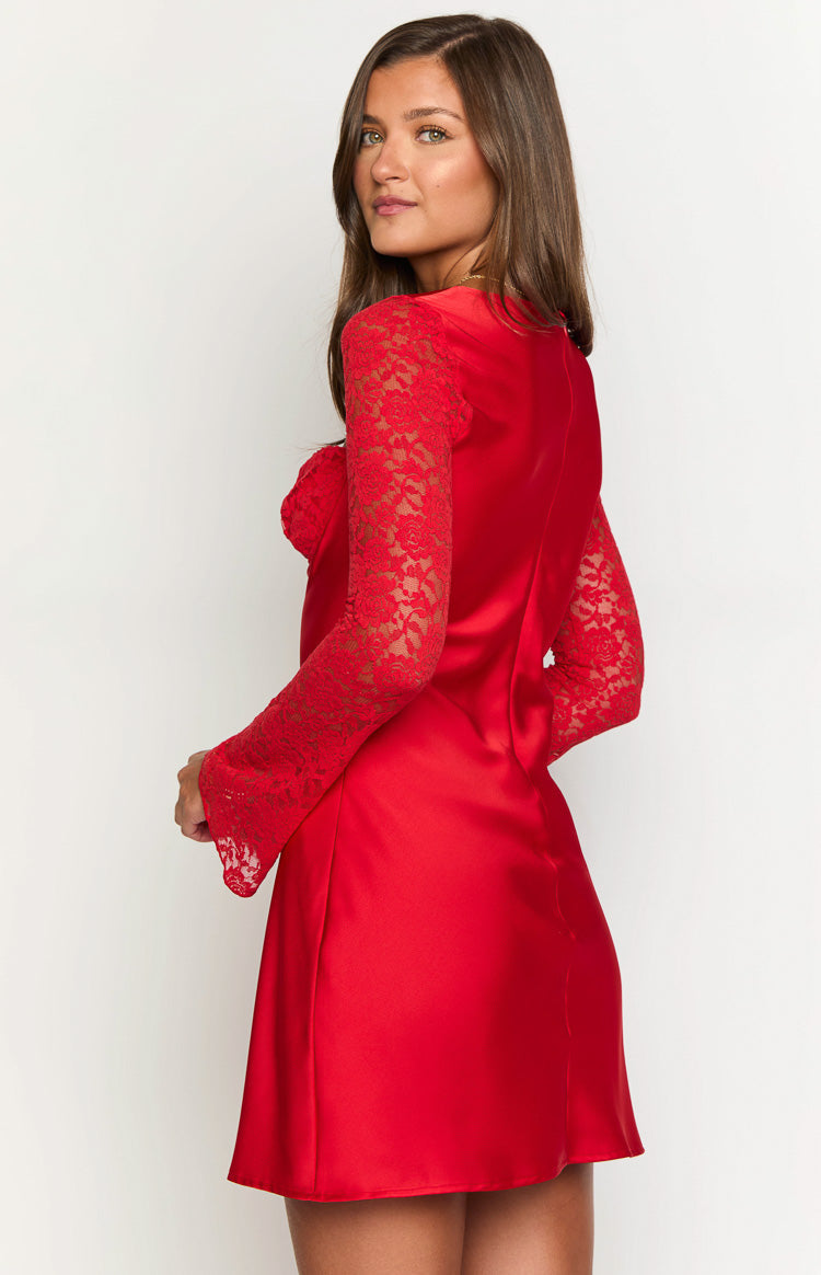 Side view of the red satin mini dress, highlighting the delicate floral lace long sleeves with flared cuffs