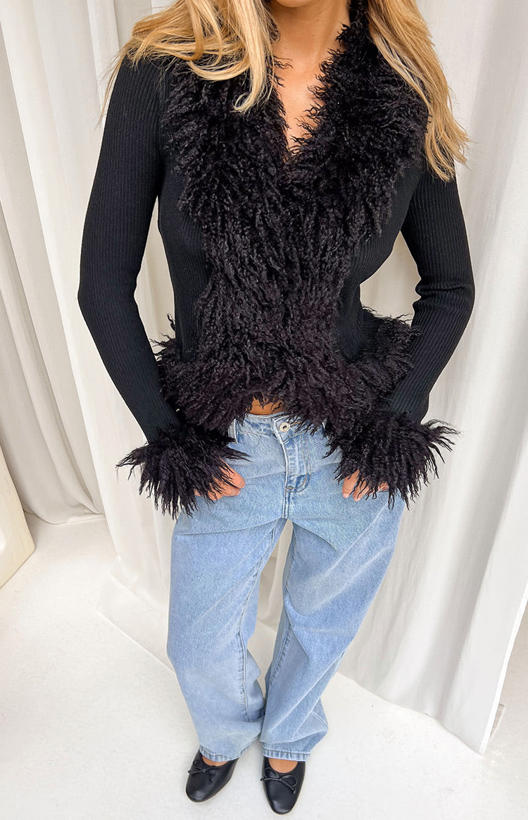 Black ribbed knit cardigan with shaggy fur trim along the V-neckline, front opening, and cuffs