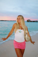 Bright pink sequin mini skirt with a gathered, layered design and a short hem