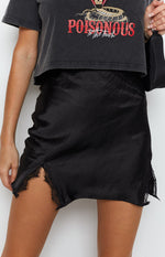 Textured black satin mini skirt with a high side slit and intricate black lace trim