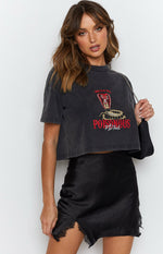 Black satin-look mini skirt with a subtle jacquard pattern, high side slit, and delicate lace trim