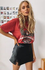 Black satin-look mini skirt with a high waist and lace-trimmed side slit