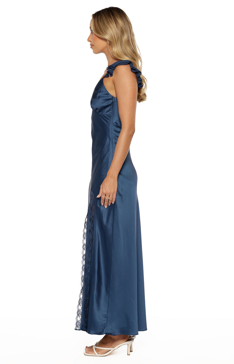 Side view of a navy satin maxi dress with ruffled shoulder straps and a lace-trimmed side split