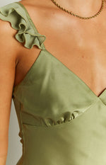 Close-up of the sage green satin maxi dress showing the ruffled shoulder strap and gathered bust detail