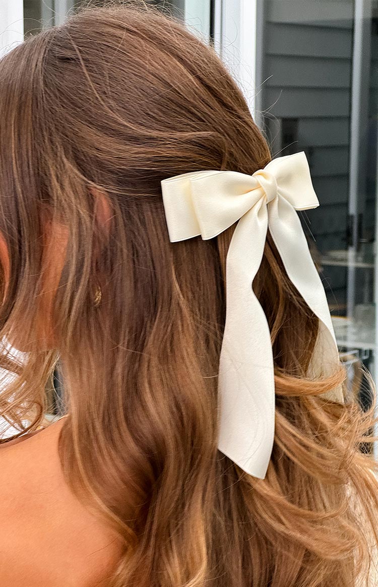  securing a half-up hairstyle.
