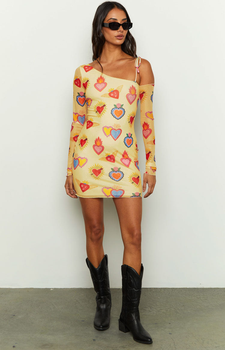 Yellow mesh mini dress with a vibrant sacred heart print, featuring an asymmetrical neckline and one long sleeve