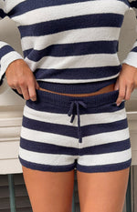 Close-up of navy and white striped knit shorts showing the ribbed elastic waistband and drawstring