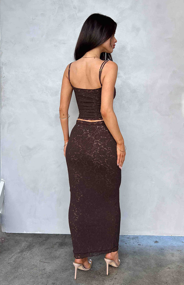 Rear view of the fitted brown lace midi skirt, showing the delicate floral pattern and midi length
