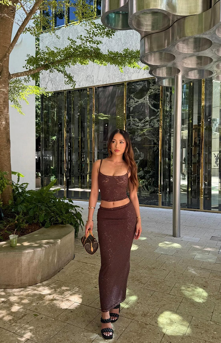 Fitted brown lace midi skirt showing its full length and intricate lace detail