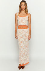 Front view of the white floral lace tank top with orange contrast trim, thin spaghetti straps, and a cropped hem