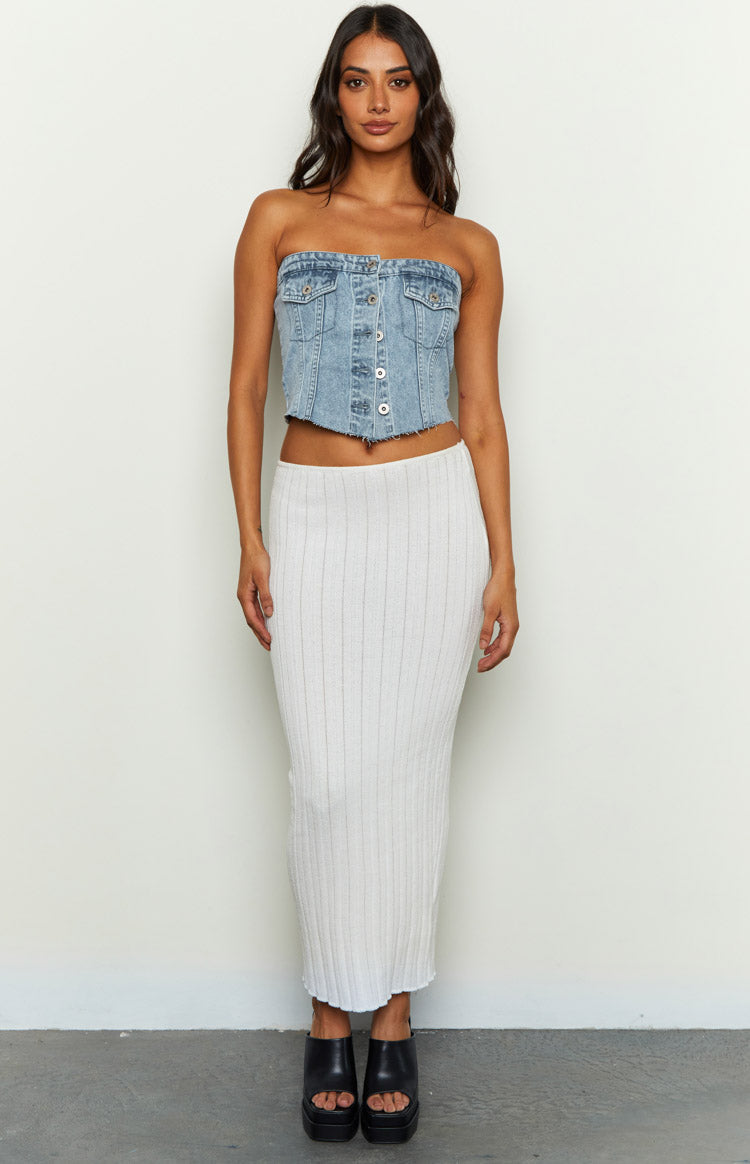 Light wash denim strapless button-front top with chest pockets and a frayed cropped hem