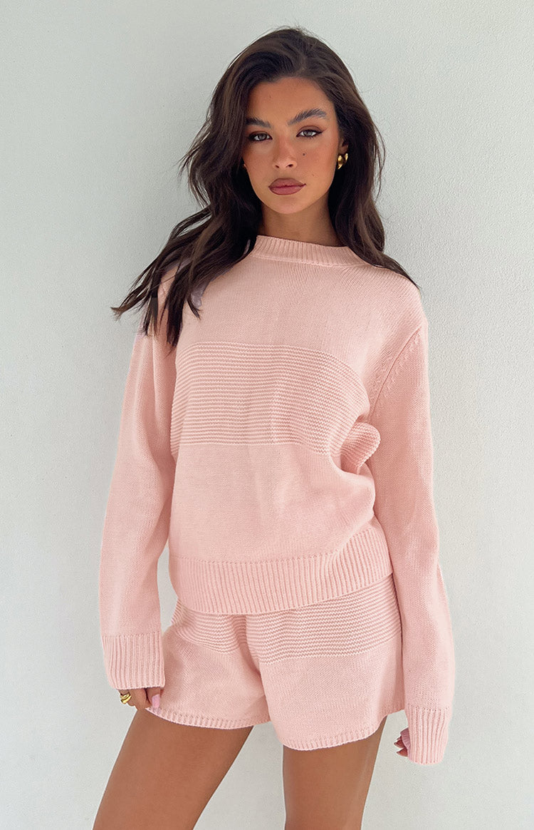 Pink long sleeve knit top with a crew neck and horizontal ribbed pattern across the chest, worn with matching knit shorts