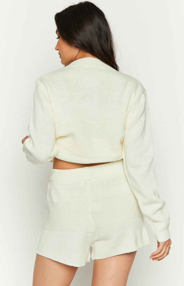 Rear view of white knit shorts with a ribbed waistband and horizontal ribbed texture panels