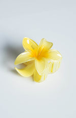 Side view of a translucent yellow frangipani flower claw clip with a brighter yellow centre