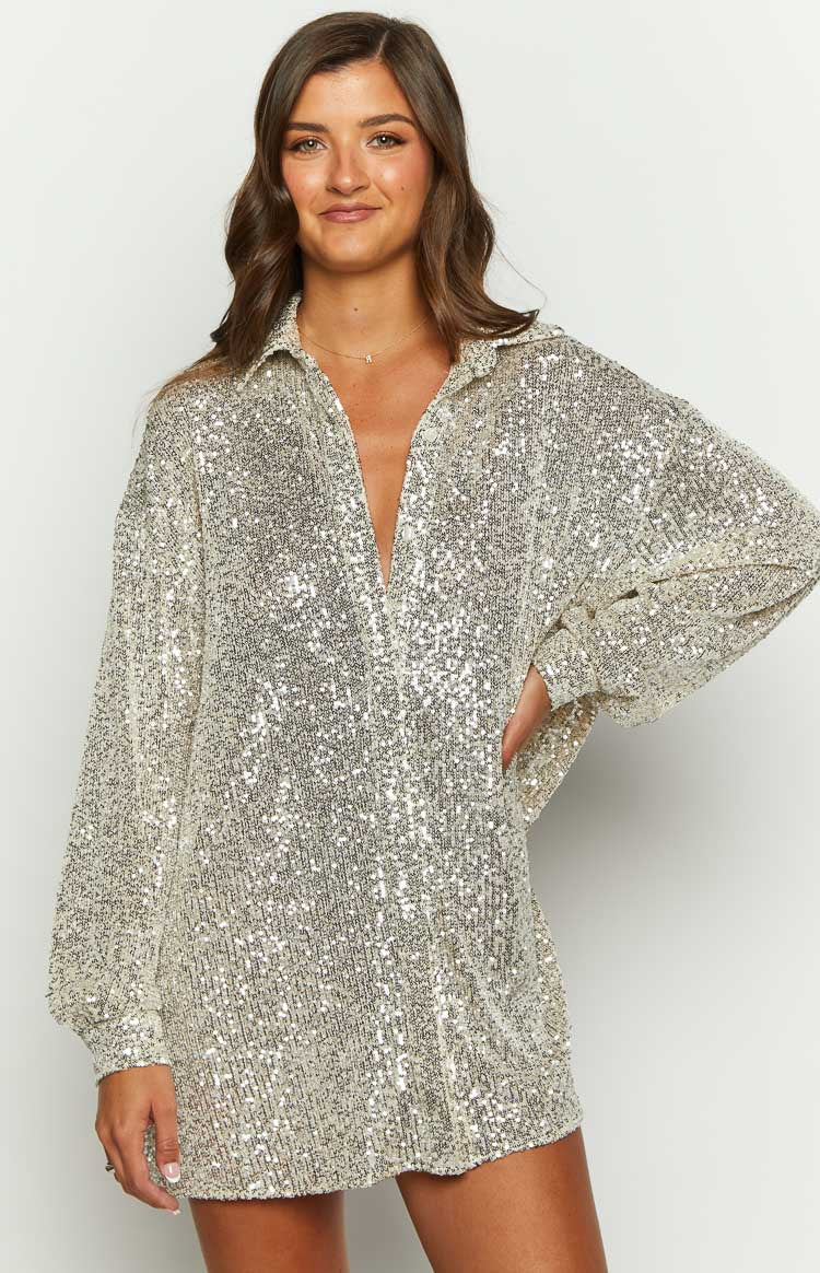 Close-up of the gold sequin long sleeve shirt with a deep V-neck collared neckline and gathered cuffs