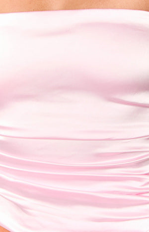 Close-up of the ruched detail on the pink satin strapless top showing its soft sheen and gathered texture