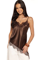 A lifestyle shot of our model wearing a shimmering chocolate brown satin camisole. This top features thin spaghetti straps a V-neckline framed by intricate dark brown floral lace and a matching lace-trimmed hemline.