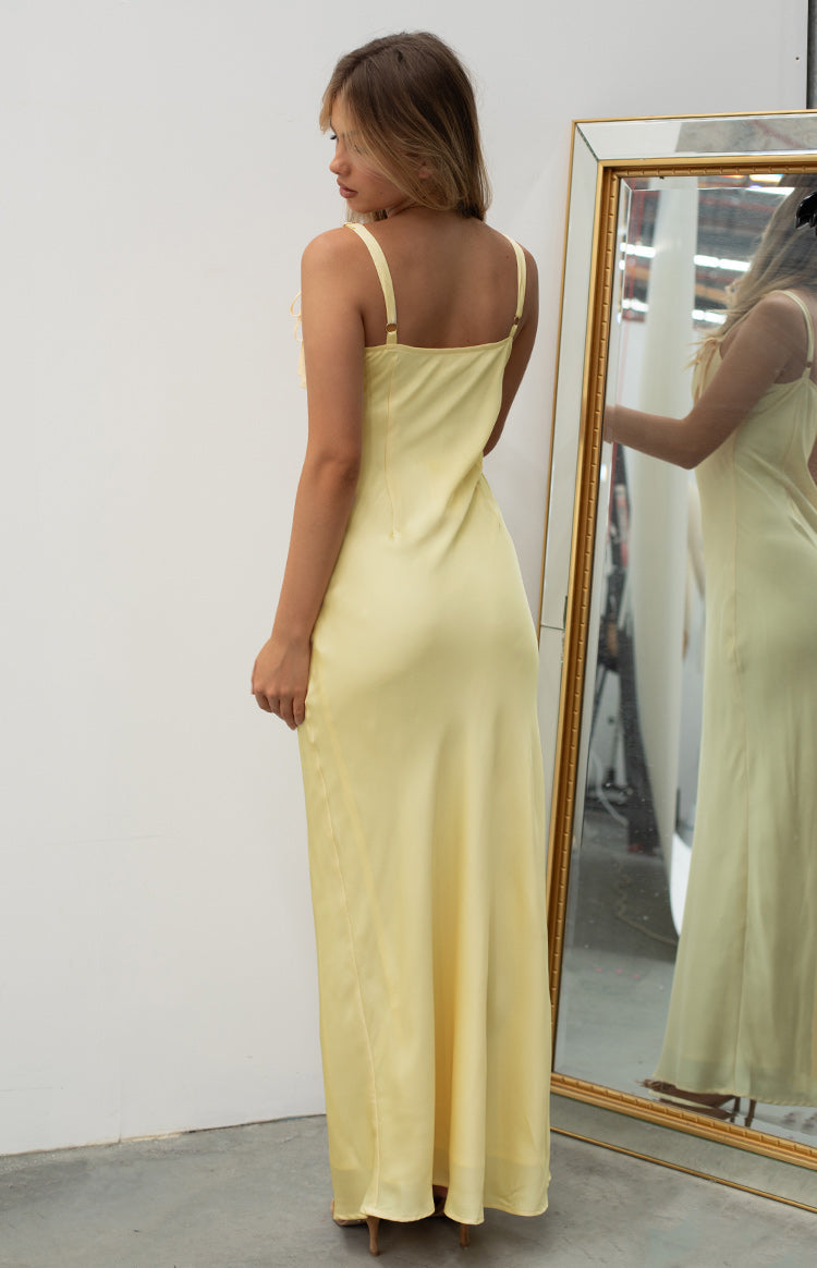 Rear-side view of a yellow satin maxi dress with adjustable spaghetti straps and a square back