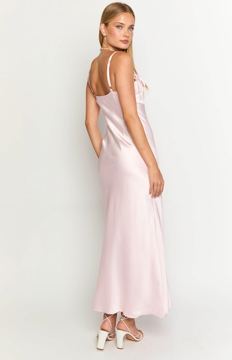 Side profile of the light pink satin maxi dress, showing the bust tie detail and elegant drape