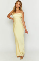 Full length front view of a yellow satin maxi dress with a square neckline and tie-shoulder spaghetti straps