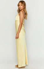 Side view of a yellow satin maxi dress with tie-detail spaghetti straps and a relaxed fit