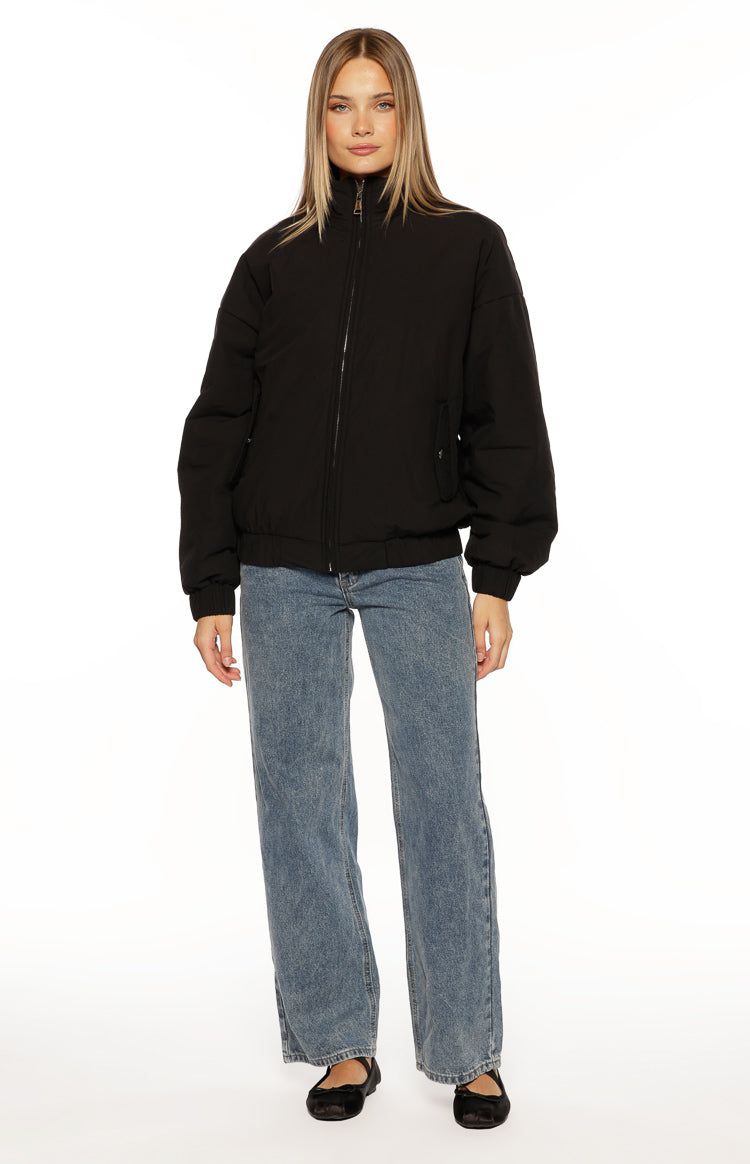 Oversized black puffer jacket featuring a high stand collar, full zip, and elasticated cuffs and hem