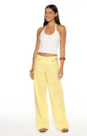 Rear view of yellow wide-leg pants with a relaxed fit and lightweight textured fabric