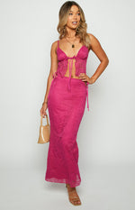 Fuschia fitted lace maxi skirt with side tie details, paisley pattern, and sheer hem