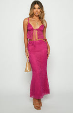 Front view of a fuschia lace cropped top with a tie-up front, thin spaghetti straps, and a delicate paisley pattern