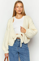 Beginning Boutique Holiday Cream Tie Up Knit Cardigan cream chunky knit cropped cardigan with deep V-back and tie detail