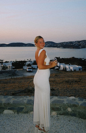 Rear view of a cream mesh maxi dress with an open back and side waist cutouts