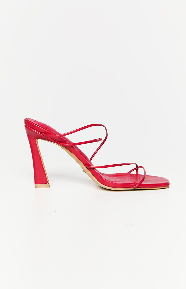 Side view of strawberry red strappy heels with a flared sculptural block heel and square toe