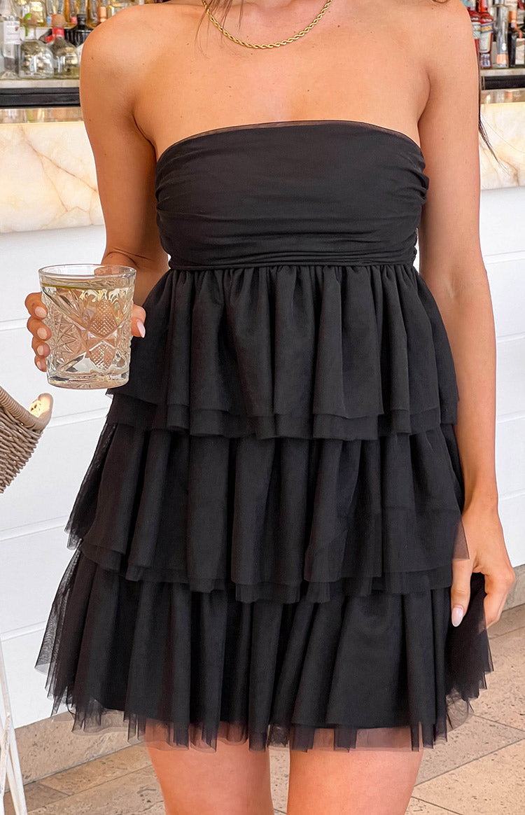 Black strapless mini dress with a ruched bodice and a voluminous tiered tulle skirt