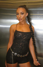 Black lace playsuit with a square neckline, thin spaghetti straps, and short leg length