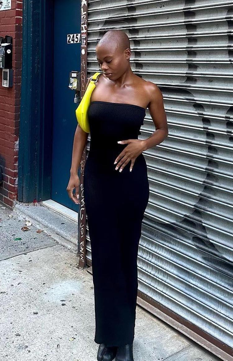 Fitted black ribbed knit strapless maxi dress with an asymmetric hem