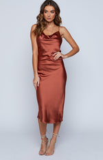 Rust satin midi dress with a draped cowl neck and a sleek, fitted silhouette