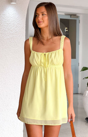 Beginning Boutique Brooke Yellow Mini Dress light yellow babydoll mini dress with square neck tie front and ruched straps