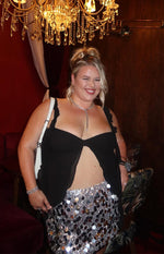 Black chiffon top with a tie-front detail creating a midriff cutout and ruffled shoulder straps