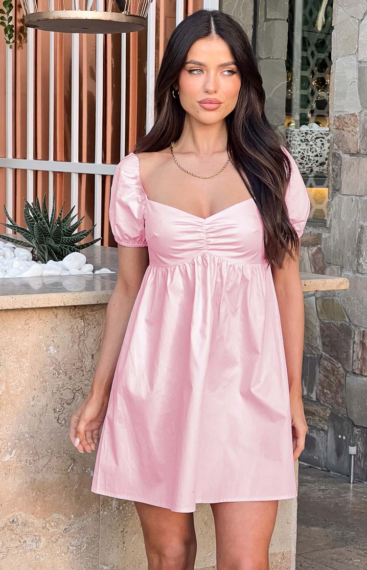 Sweetheart neckline with ruched bust detail and short puff sleeves on a pink mini dress