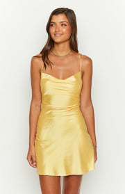Yellow satin mini dress with a cowl neckline, delicate spaghetti straps, and a fitted bodice