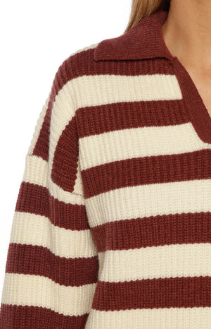 Model wearing a burgundy and cream striped knit polo sweater a cozy layer for a cool Festival night