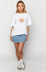 White oversized tee with a colourful graphic print of a bear, 'Duvet Day' text, and pink and blue flowers
