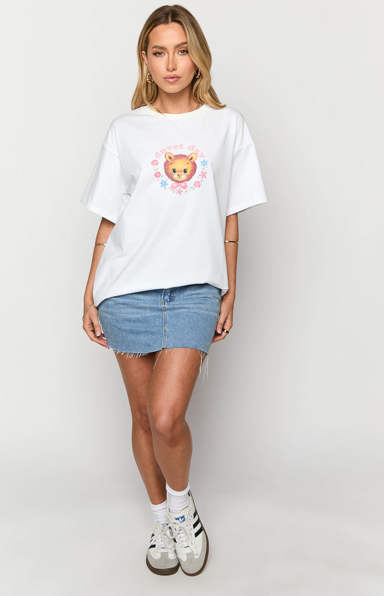 White oversized tee with a colourful graphic print of a bear, 'Duvet Day' text, and pink and blue flowers