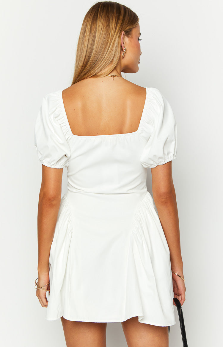 Rear view of a white mini dress with a square back neckline, short puff sleeves, and gathered details on the skirt