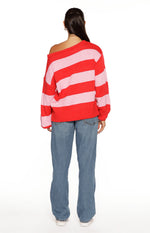 Rear view of a red and pink striped off-shoulder knit sweater with a relaxed fit