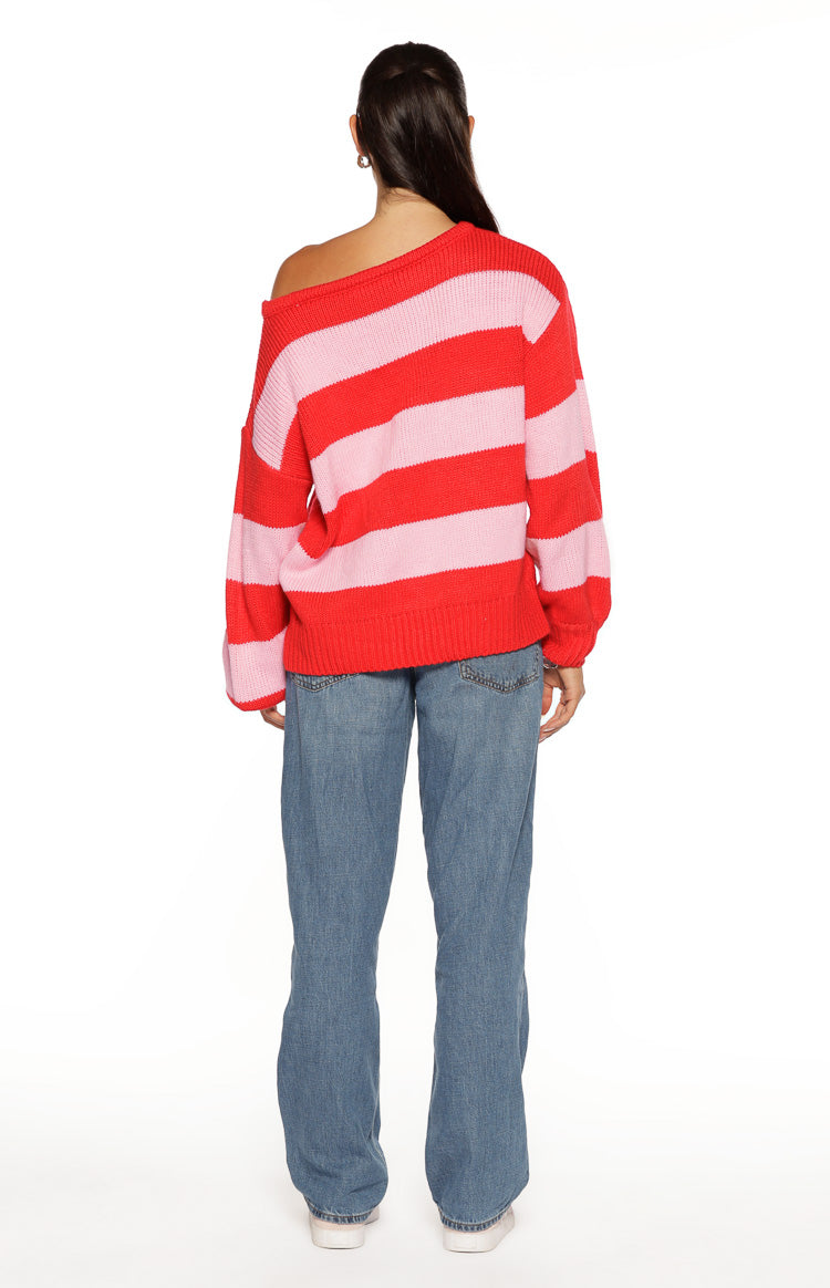 Rear view of a red and pink striped off-shoulder knit sweater with a relaxed fit